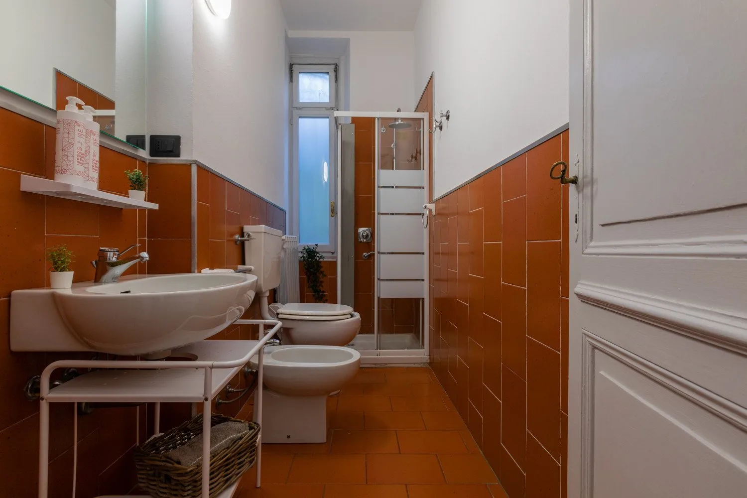 A bathroom with a sink, toilet, and shower.
