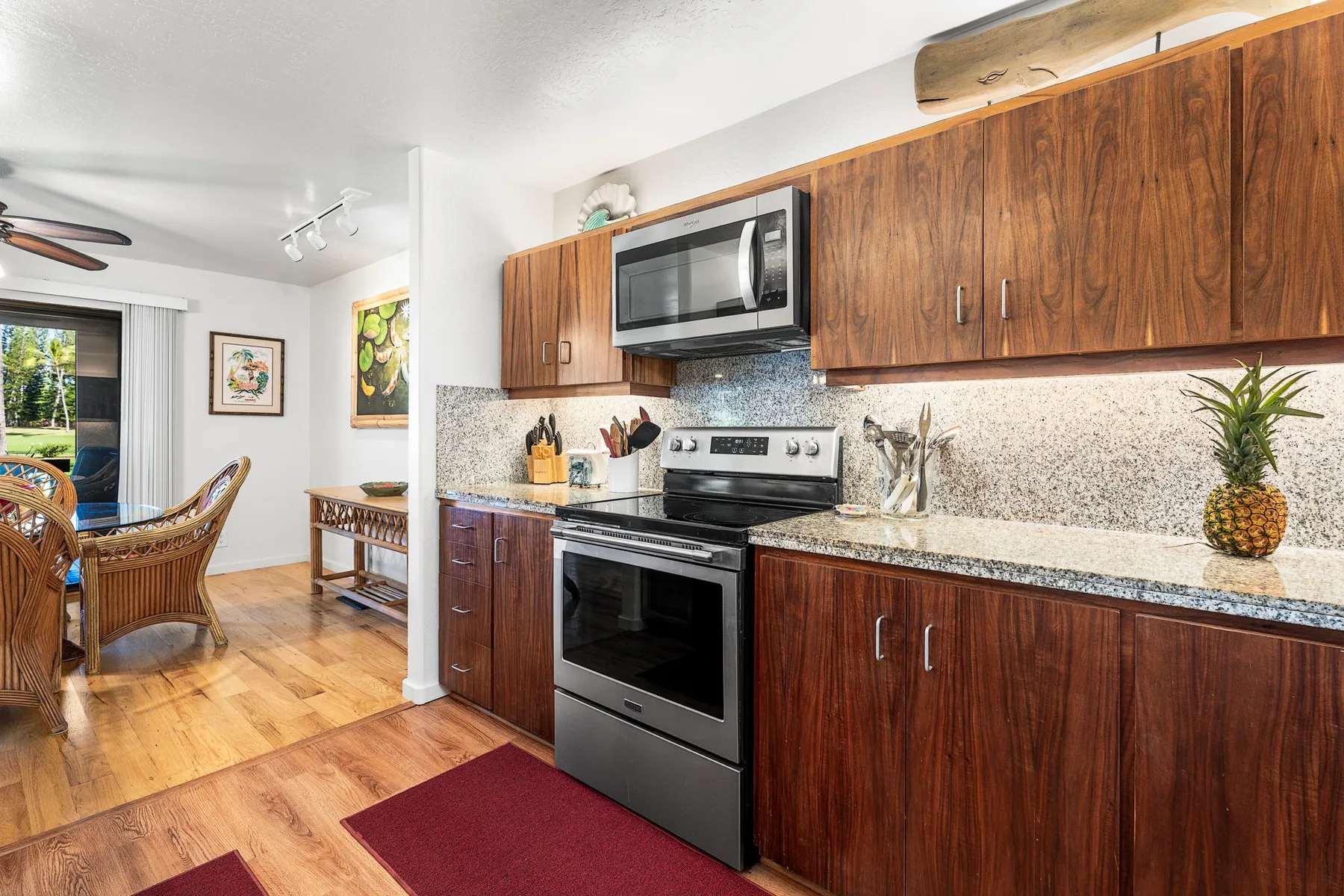 A kitchen with wood cabinets, a stove, and a countertop.