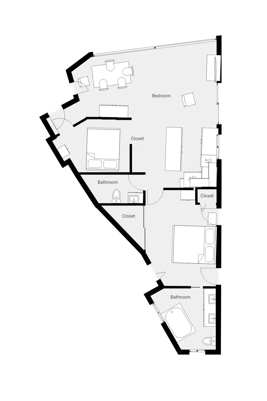 Un plano muestra un dormitorio, baños, armarios y una pequeña zona de comedor.