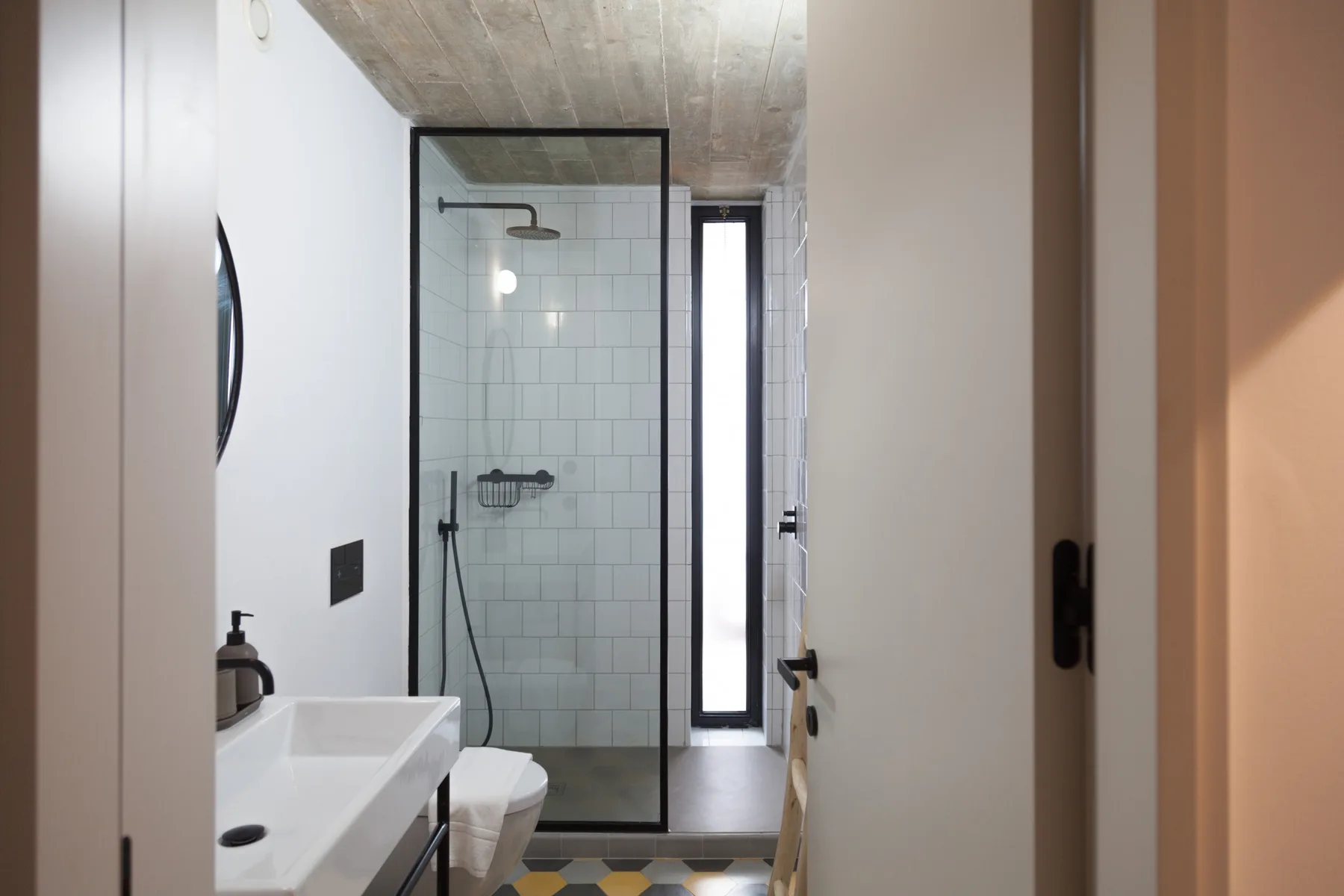 Bathroom with a sink and a glass-enclosed shower.