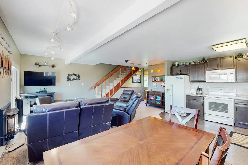 Open-plan living and dining area with kitchen and staircase.
