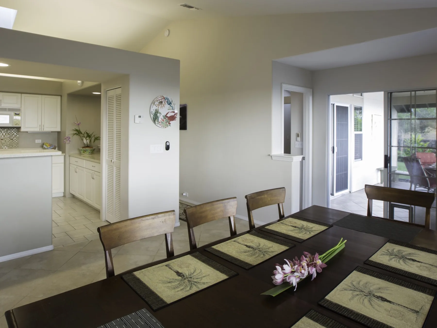 Comedor con una mesa larga y una cocina abierta al fondo.