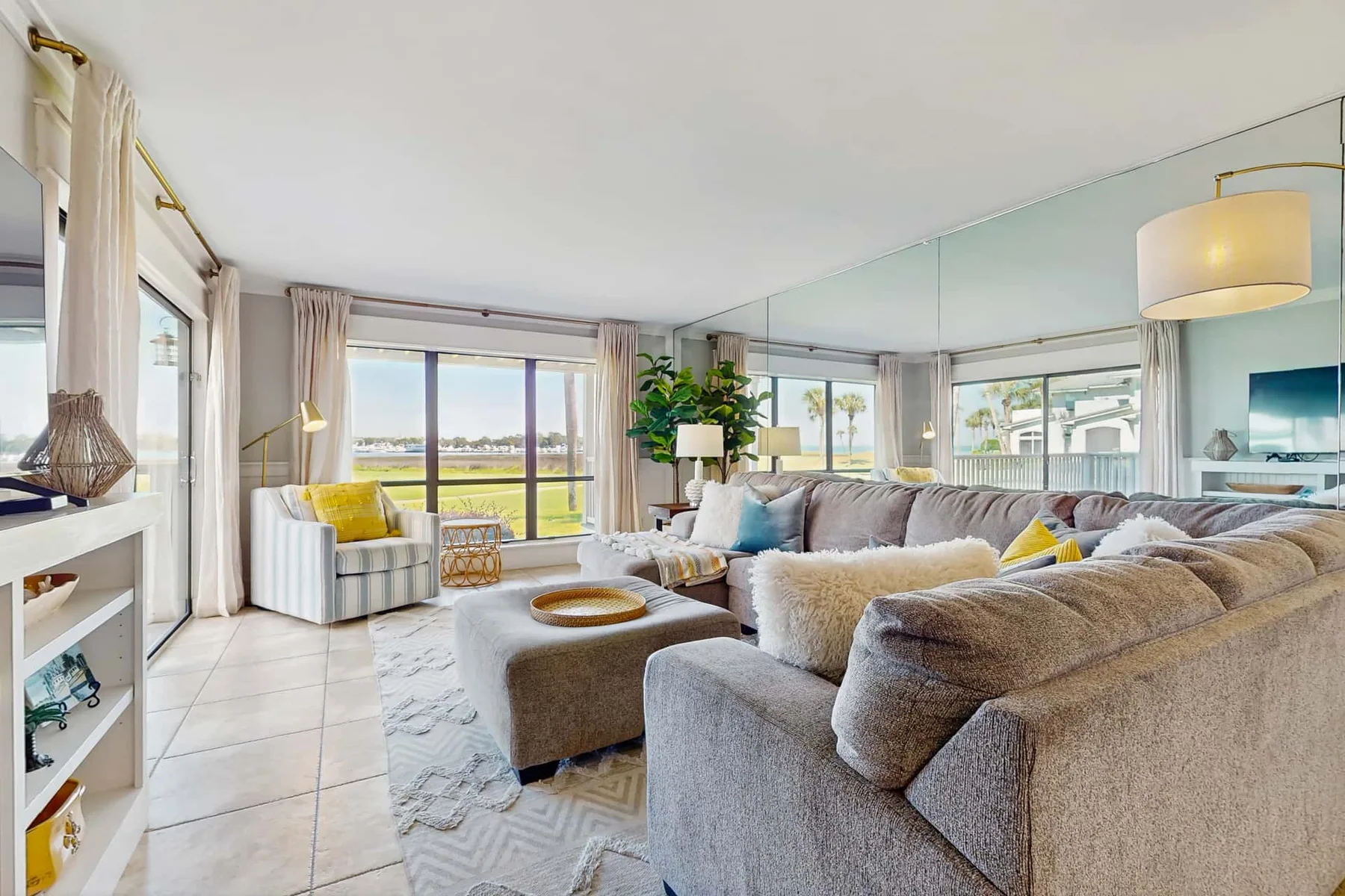 A bright living room with seating arranged around a low coffee table.