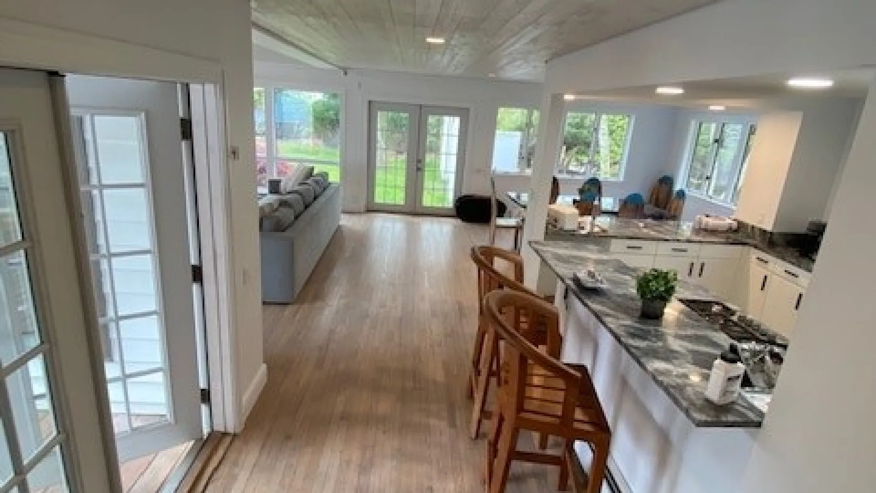 An open-plan kitchen and living area with a long island and seating.