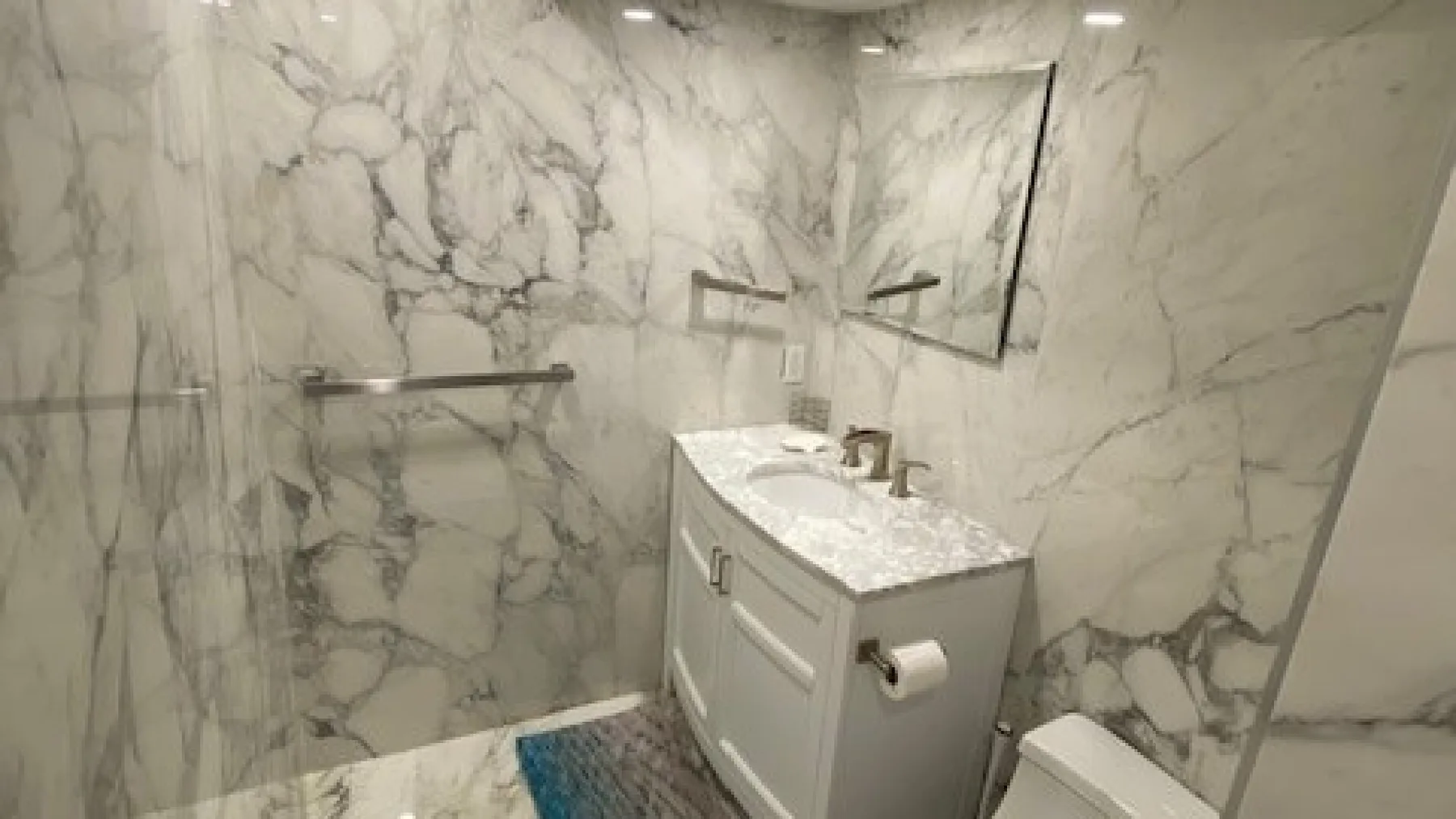 A bathroom vanity with a sink and mirror against a marble-patterned wall.