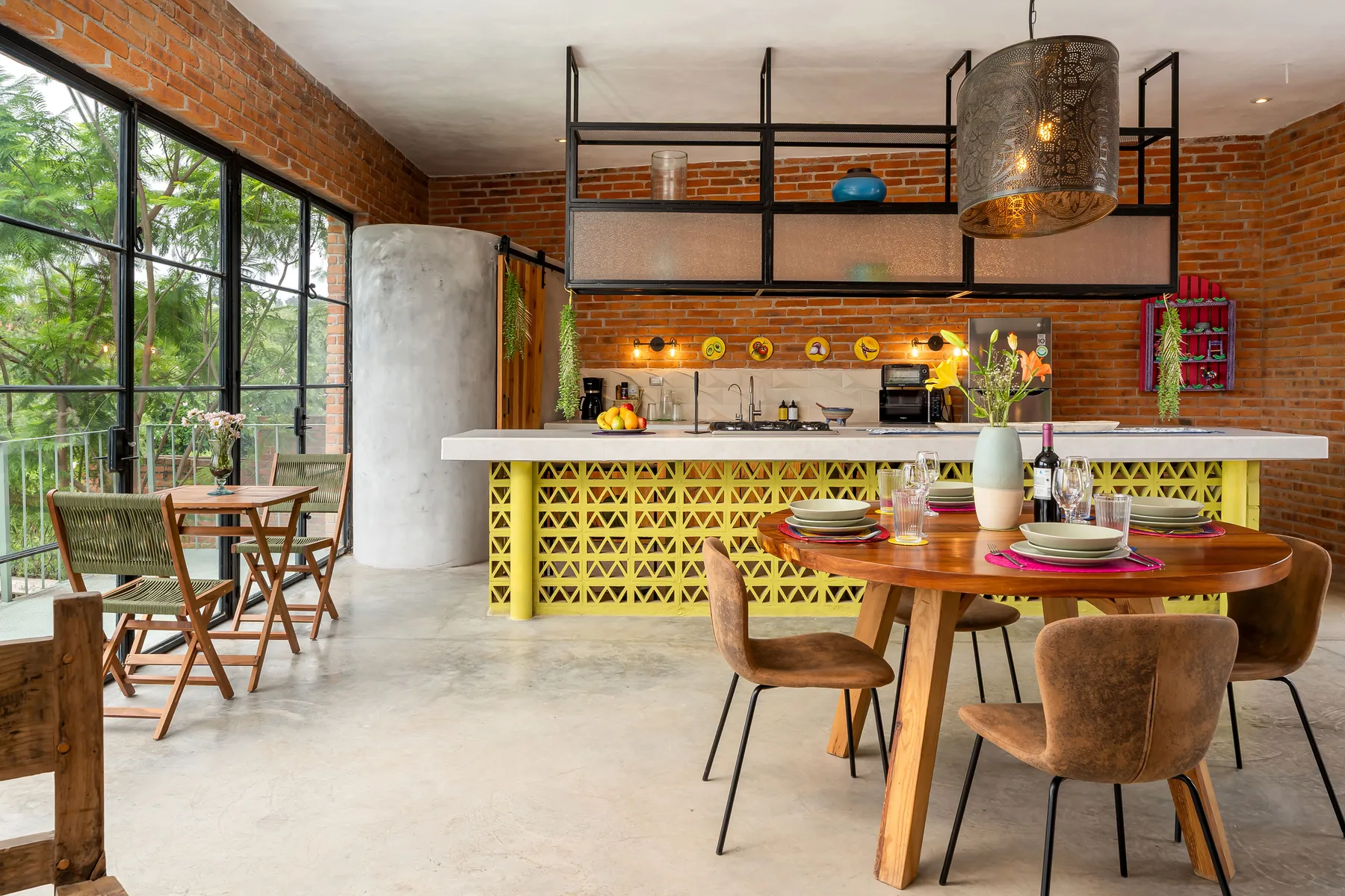 A dining area with a wooden table and seating beside a kitchen counter.