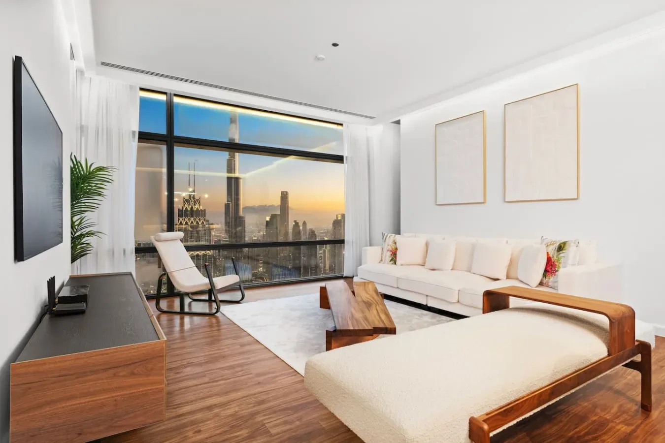 A bright living room with a large window overlooking the city skyline.