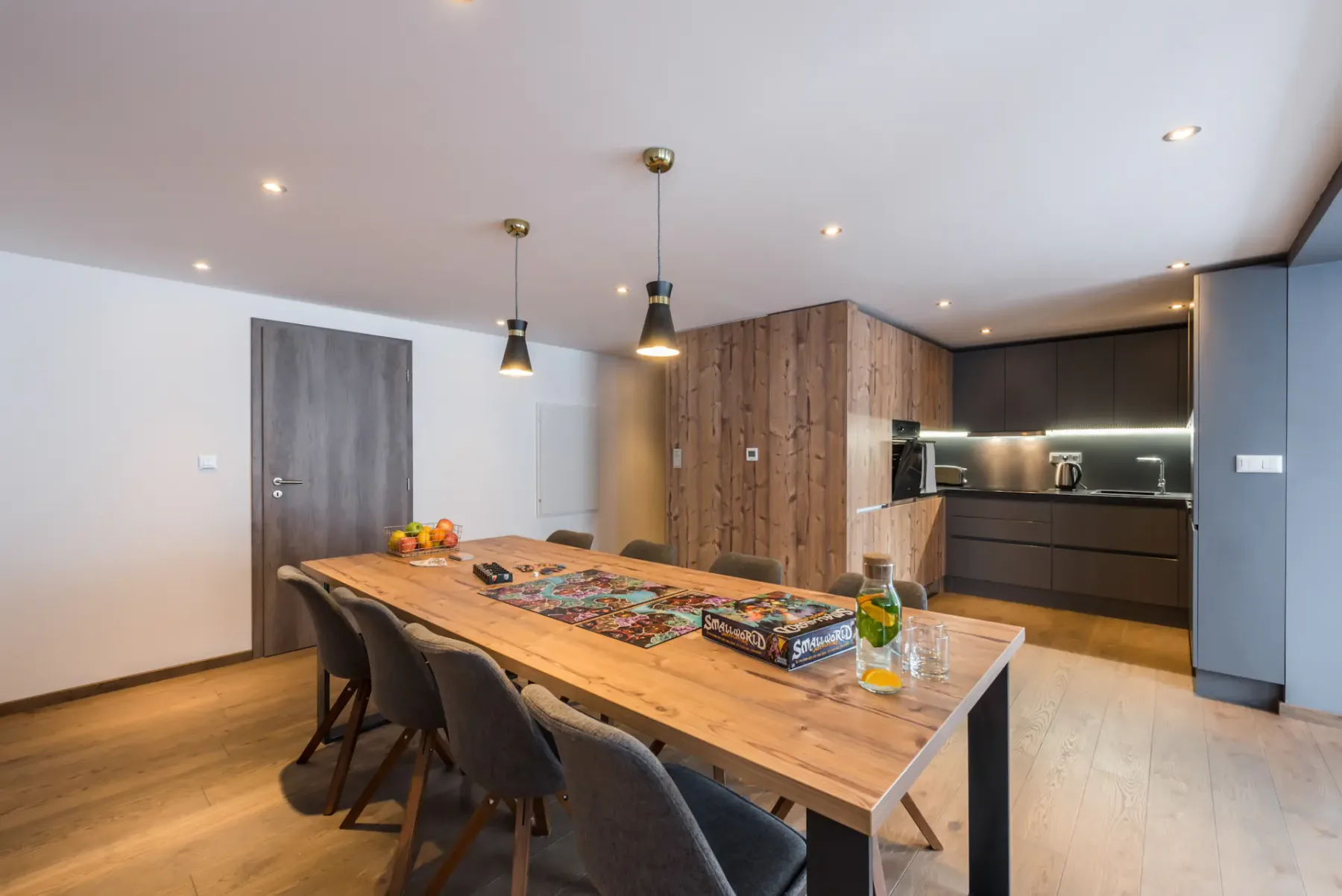 Wooden dining table and board games at Ayan accommodation in Morzine