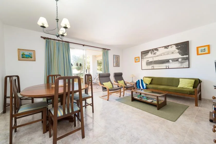 A living and dining room with seating, a coffee table, and a dining table.