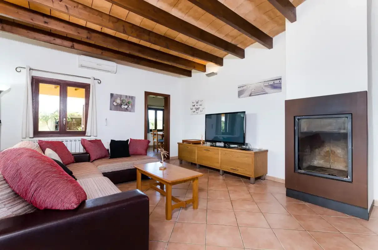 Una sala de estar con asientos, un televisor y una chimenea.