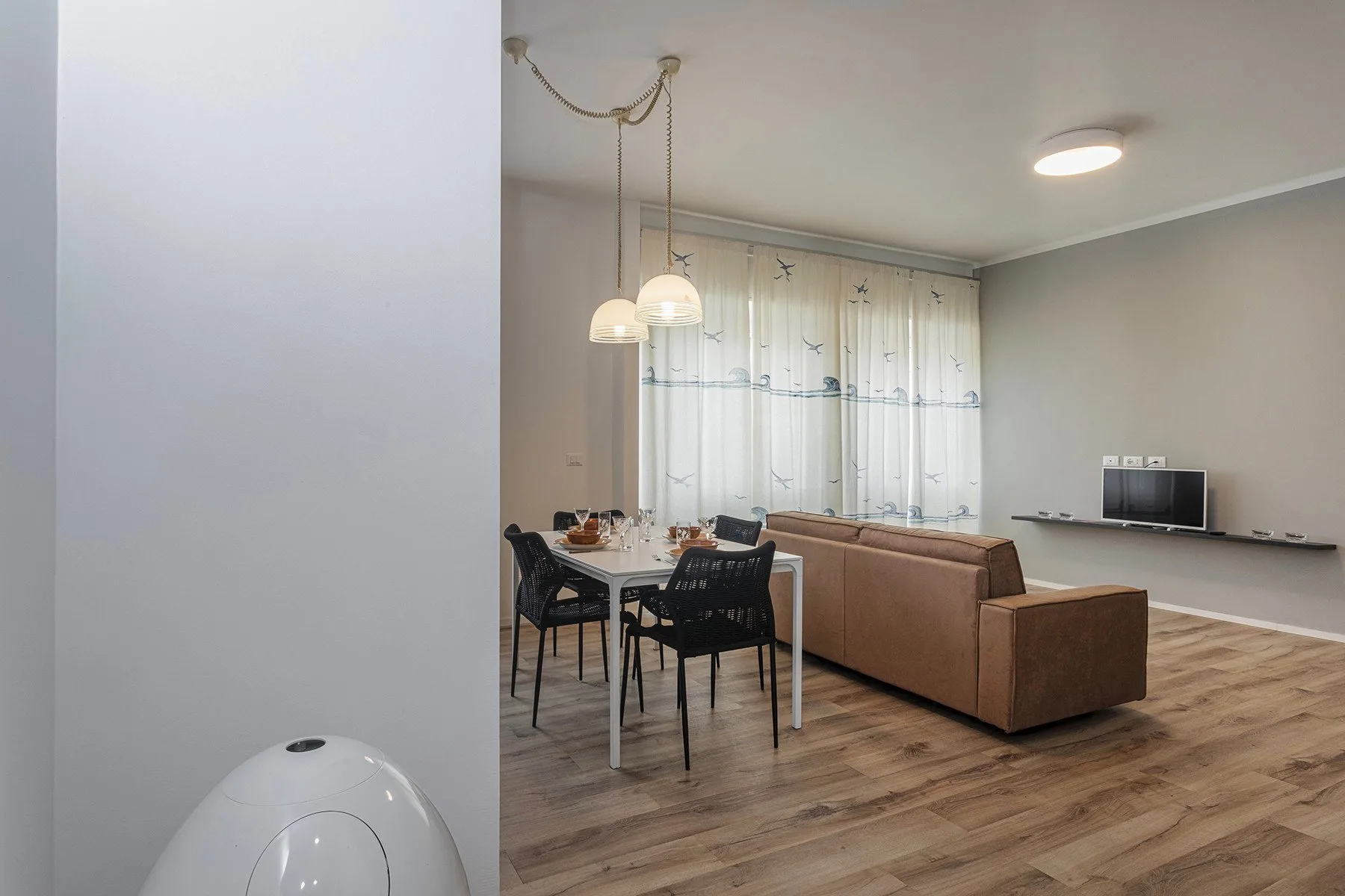 A combined living and dining area with a dining table and seating.