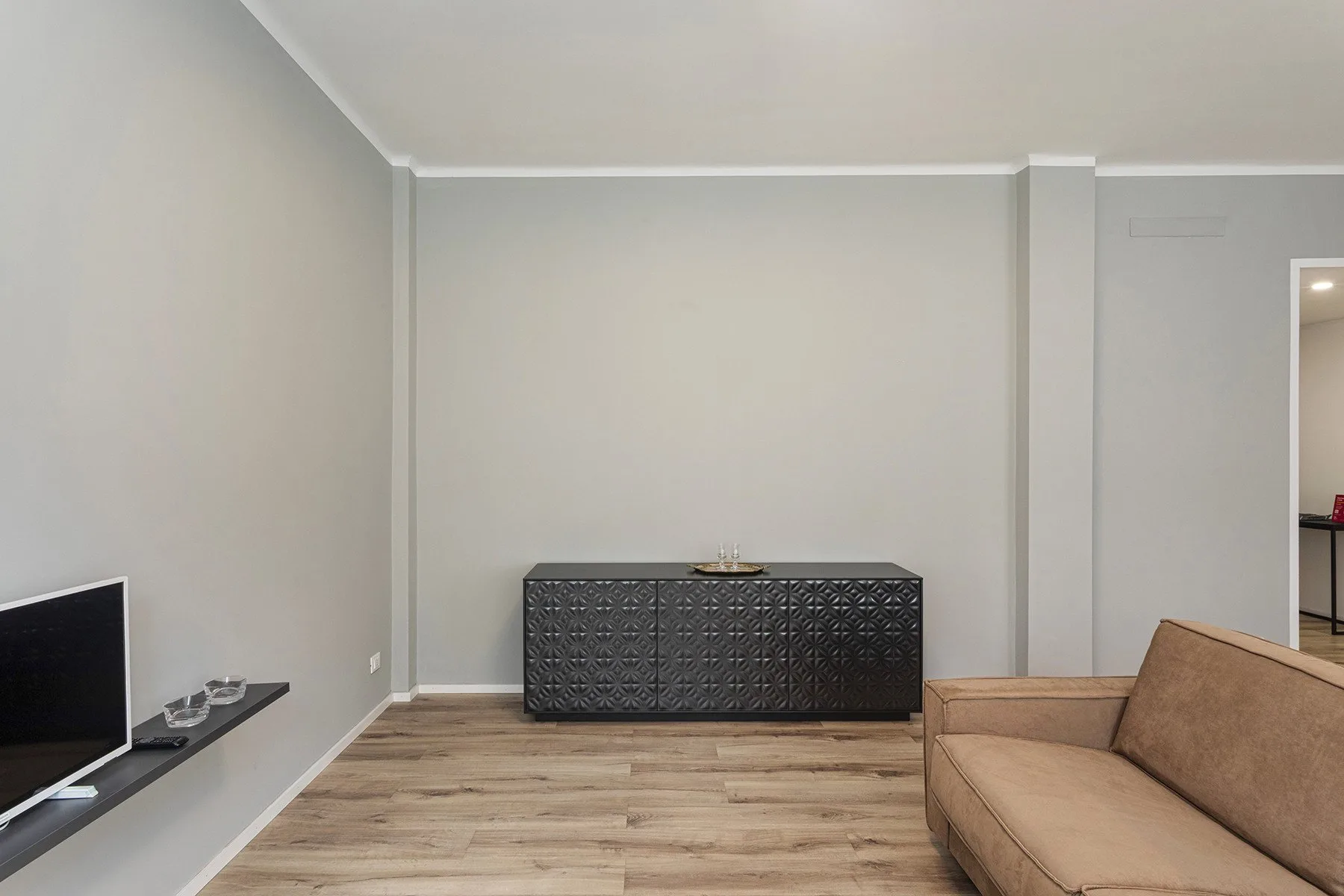 A living room with a television, low cabinet, and seating.
