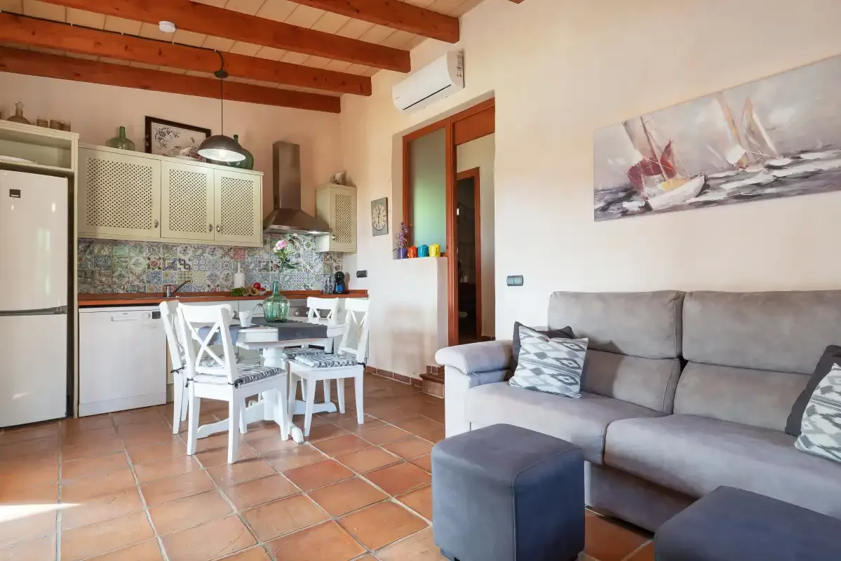 An open-plan living and dining area with a kitchen and gray seating.