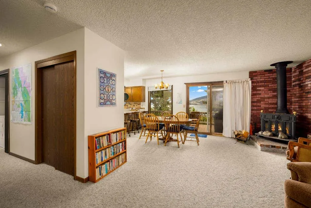 A living and dining area with a dining table and a fireplace.