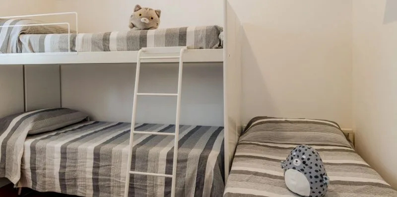 A bedroom with bunk beds and a separate single bed.