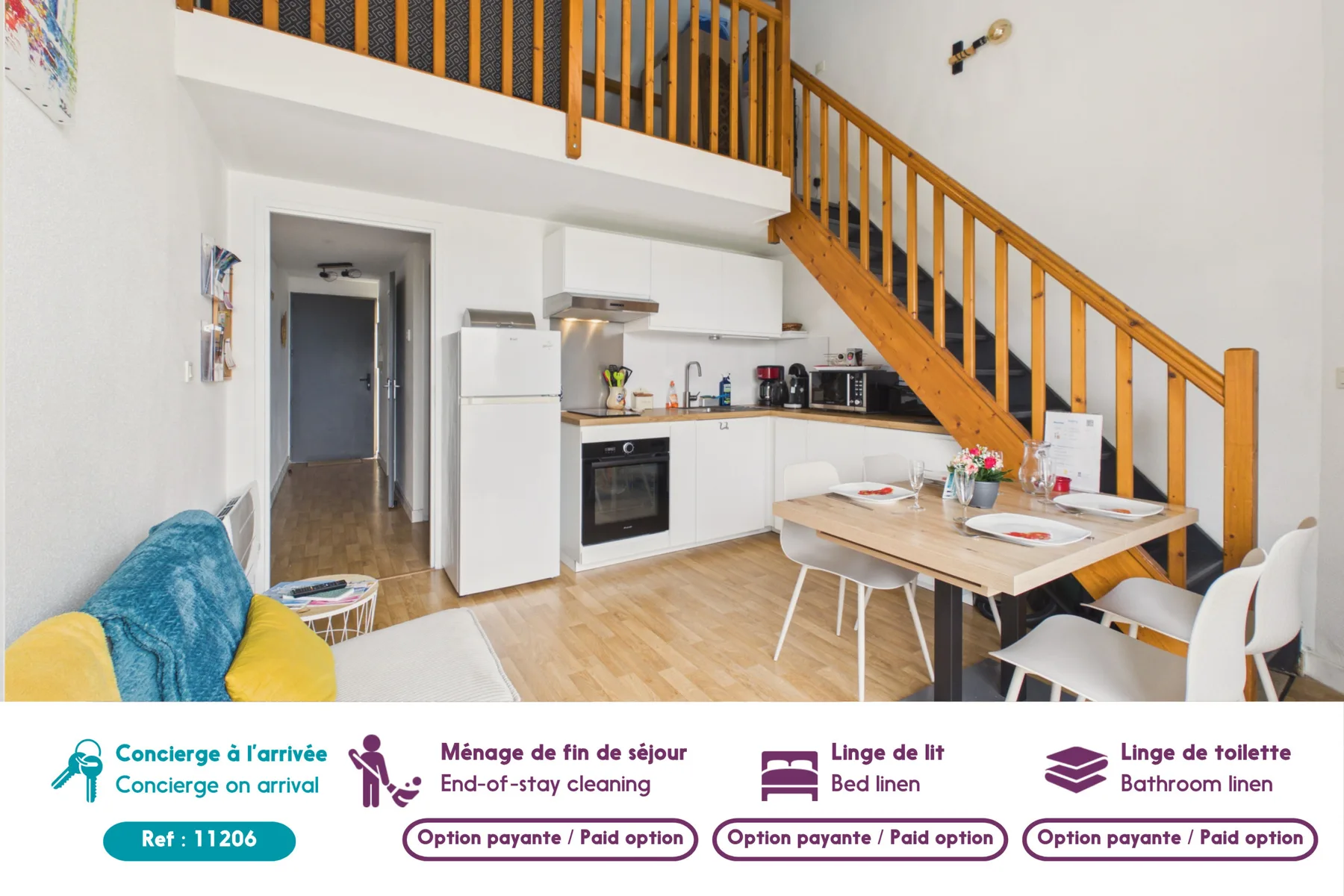 An open-plan kitchen and dining area sits beneath a wooden staircase.