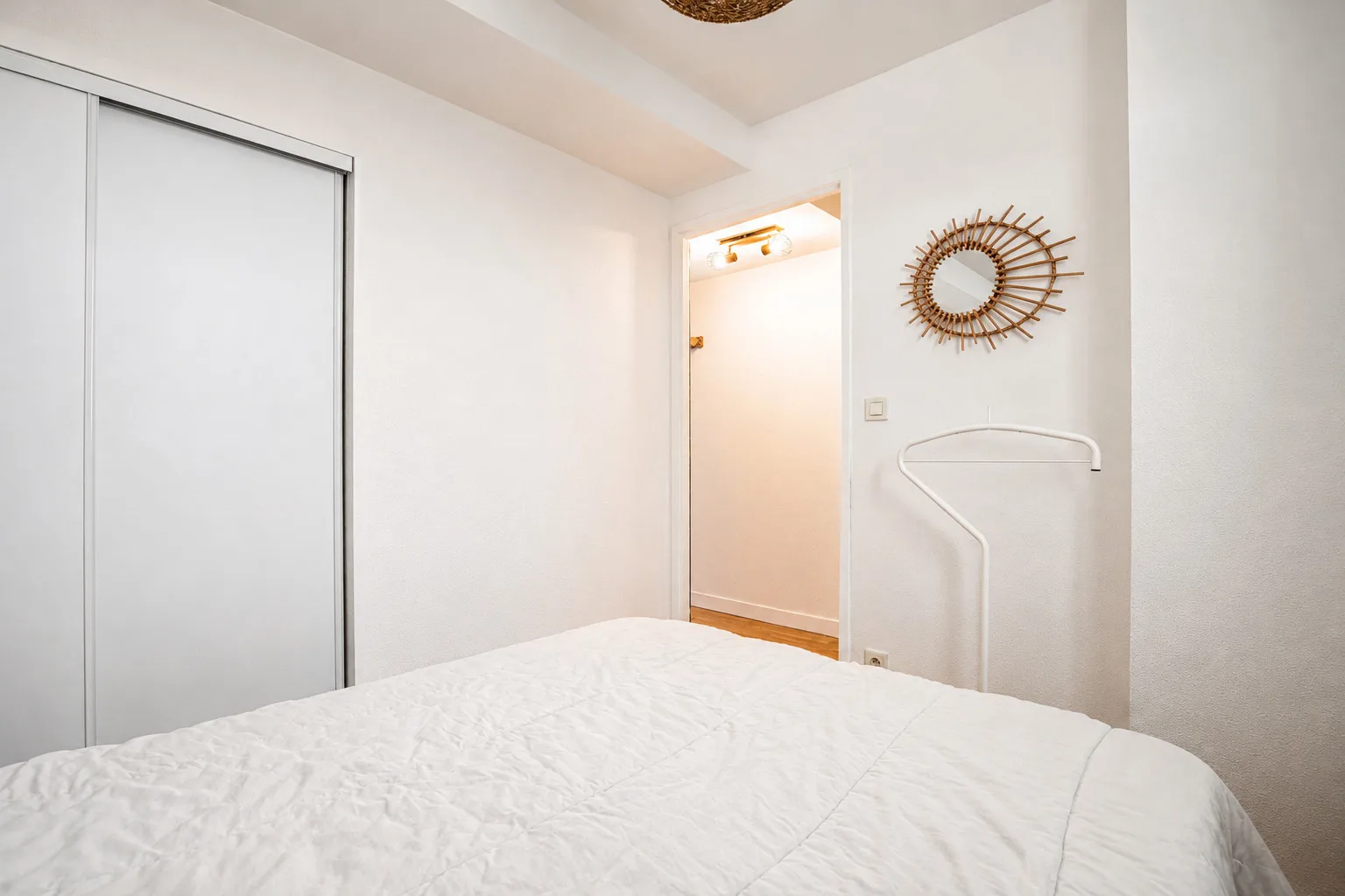 Bedroom with a bed and a sliding closet door.