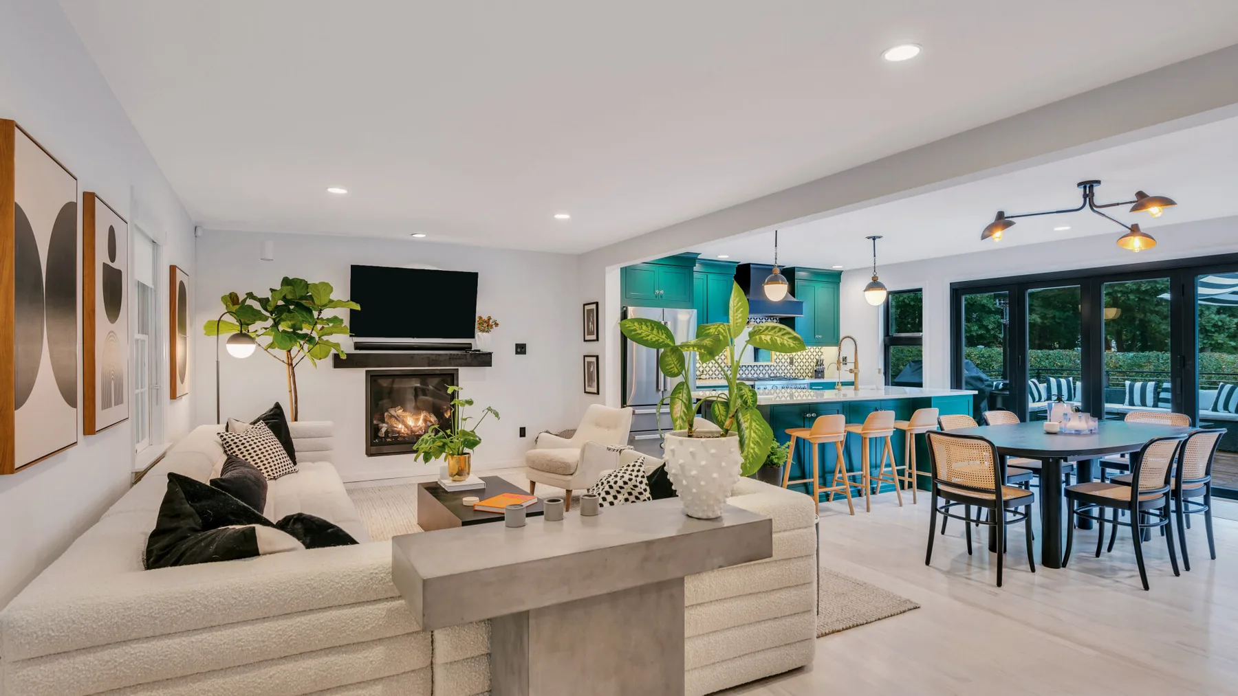 An open-plan living and dining area with seating, a table, and a kitchen.