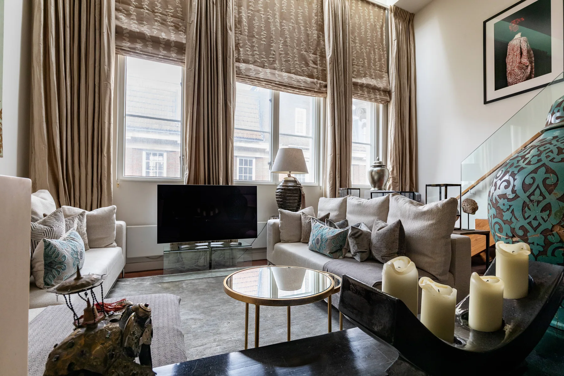 A living room with seating arranged around a coffee table and television.
