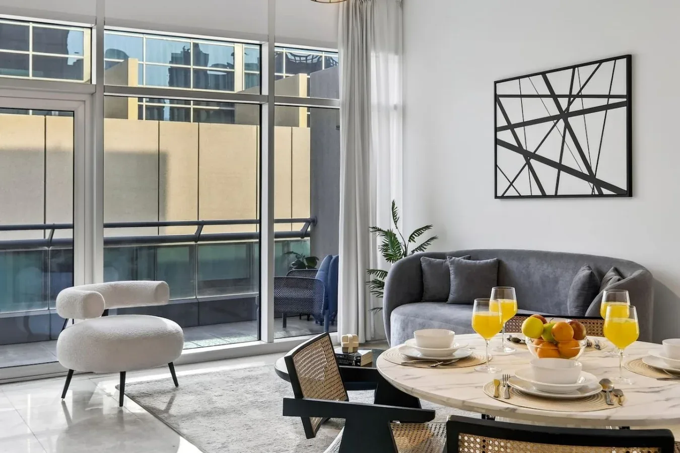 A bright dining area with a round table beside large windows.