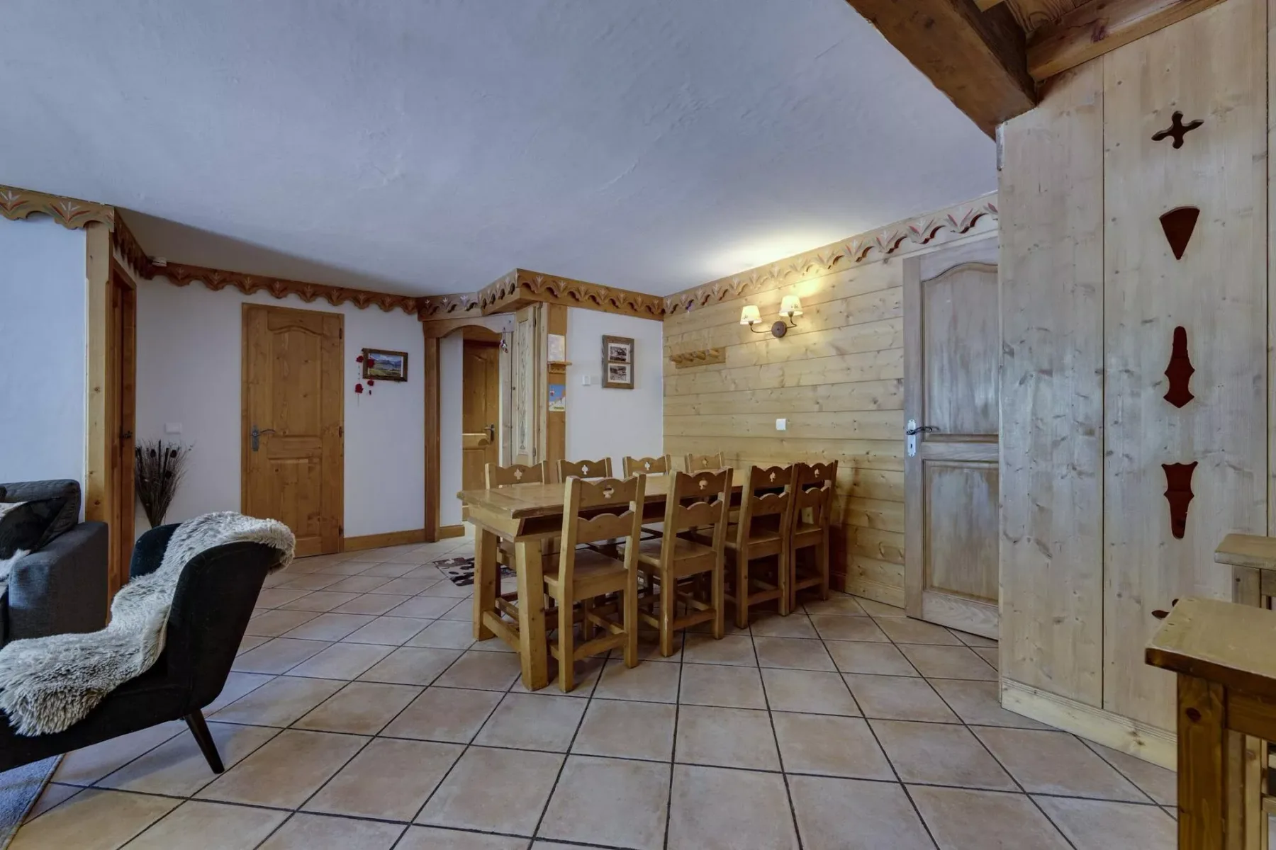 A rustic dining area with a long wooden table and chairs.