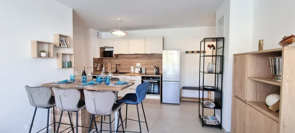 An open kitchen and dining area with a counter and bar seating.