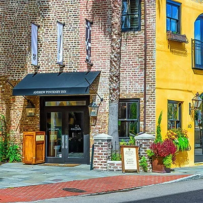 Historic inn exterior with awning and flowers