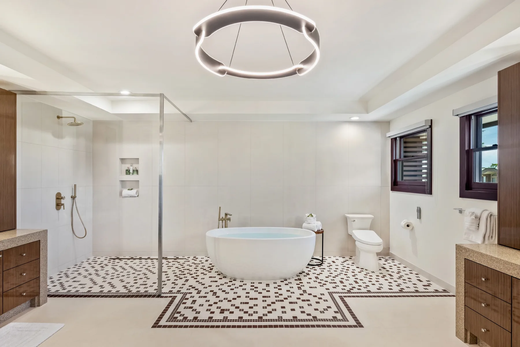 Un baño luminoso con bañera exenta, ducha e inodoro.