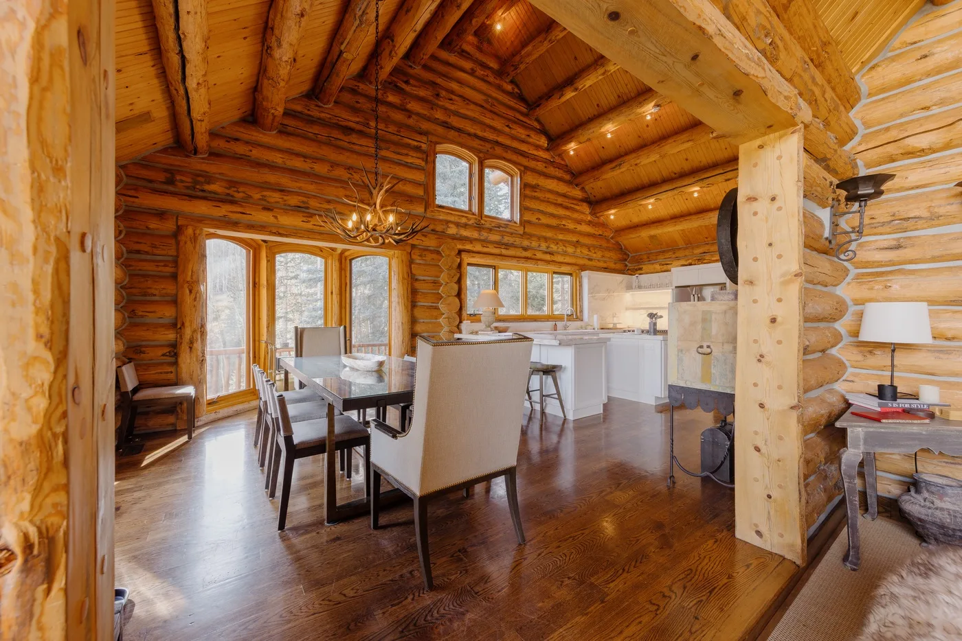 A timber interior with a dining area and open kitchen.