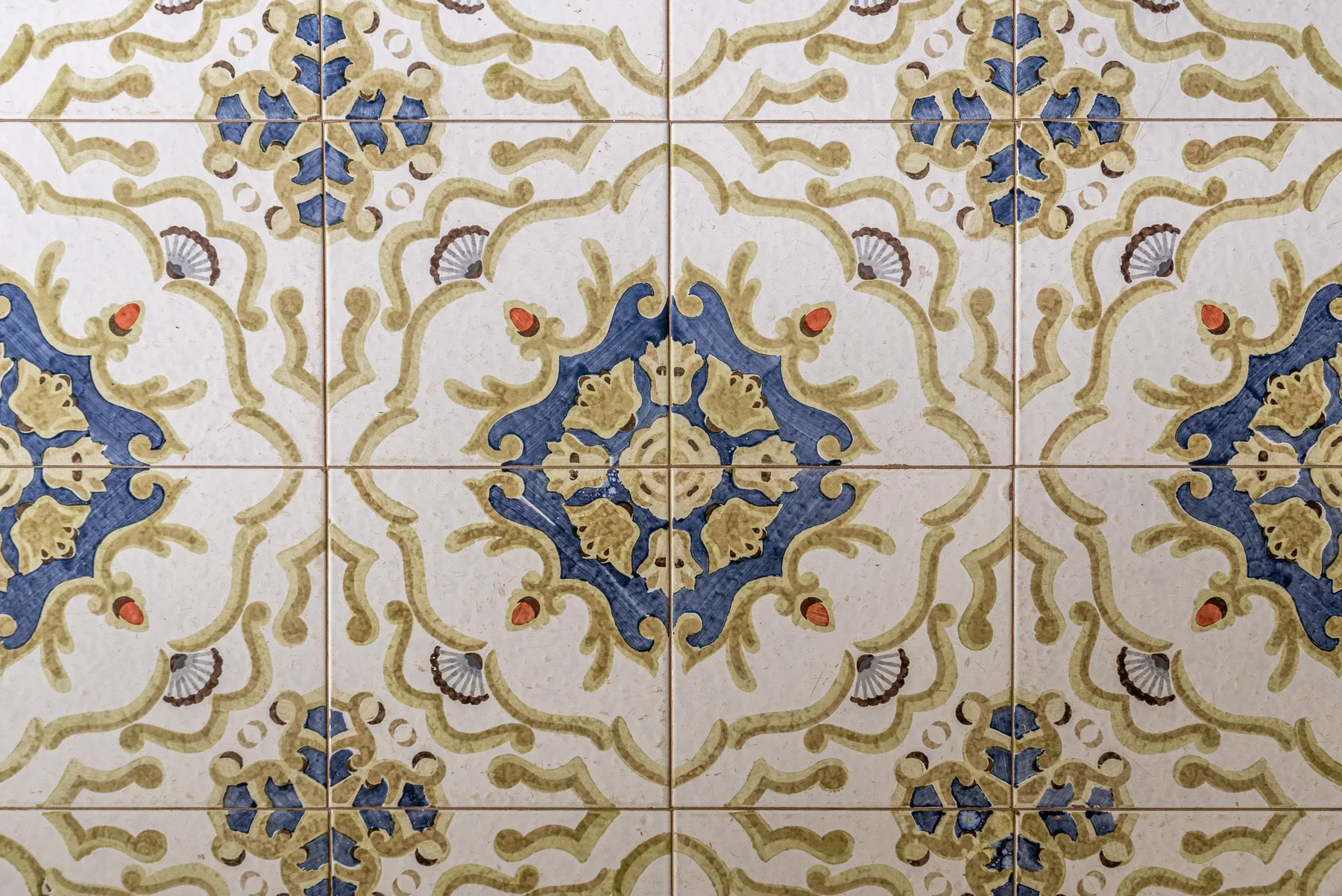 Decorative patterned tile with blue and gold floral motifs.