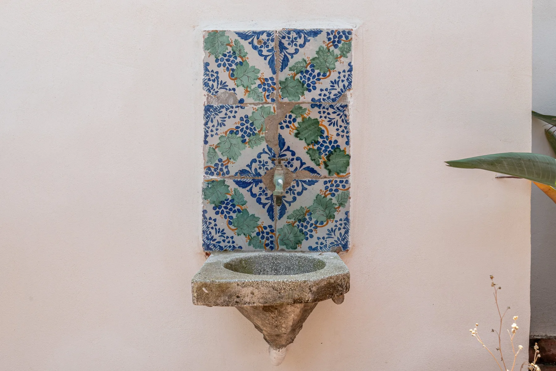 A decorative wall fountain with patterned blue and green tiles.