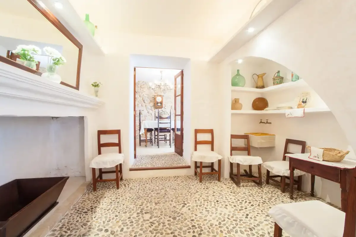A bright dining room with a table, chairs, and built-in shelves.