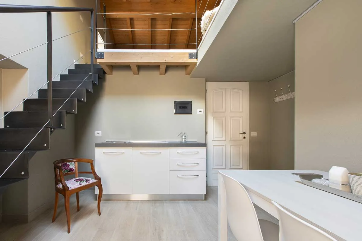 Via Set apartment entrance and kitchenette