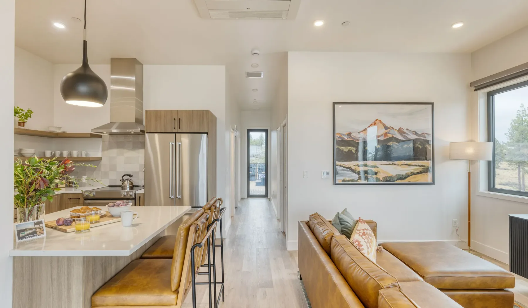 An open-plan kitchen and living area with a counter and seating.