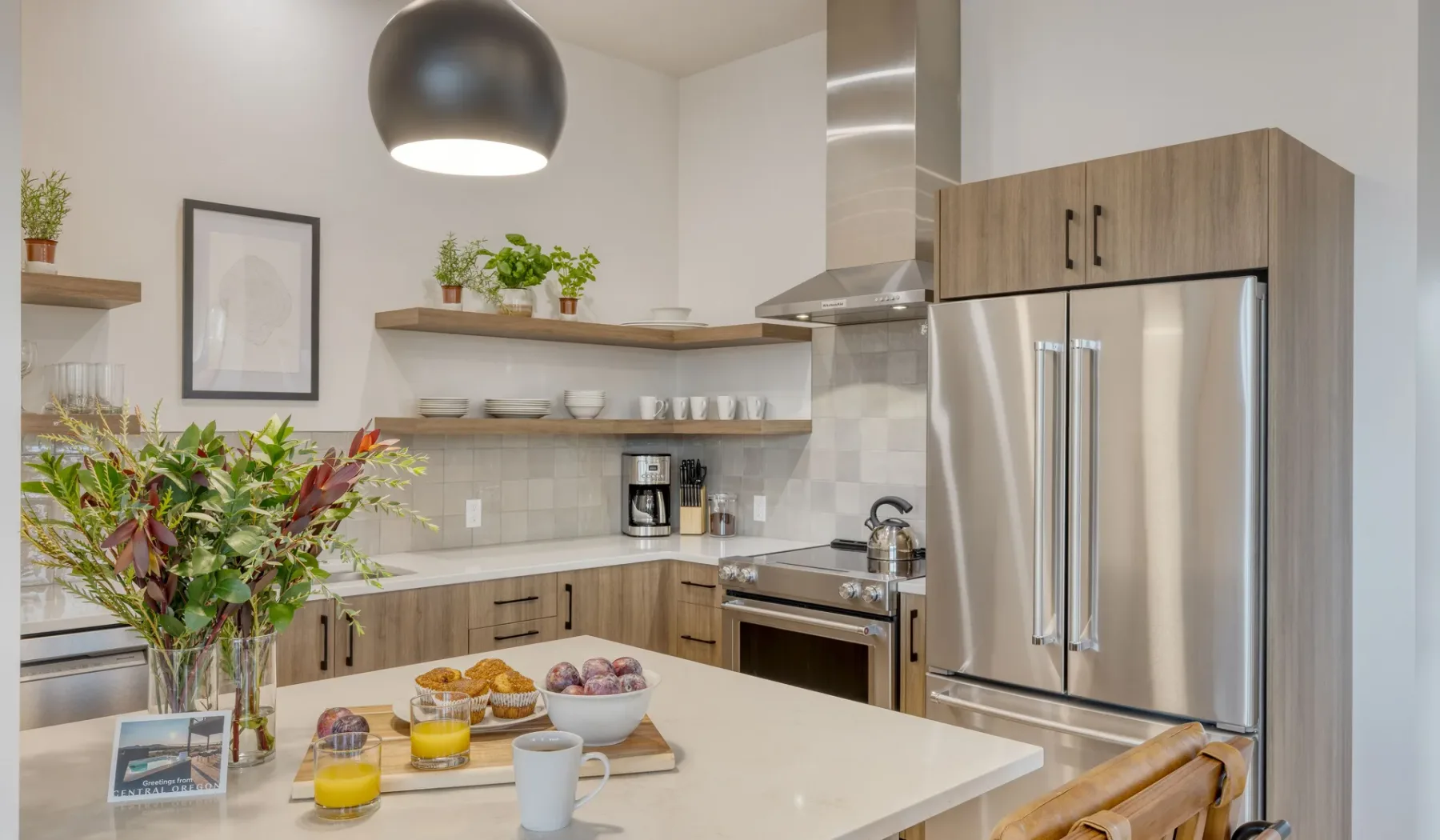 A bright modern kitchen with a large island and stainless steel appliances.
