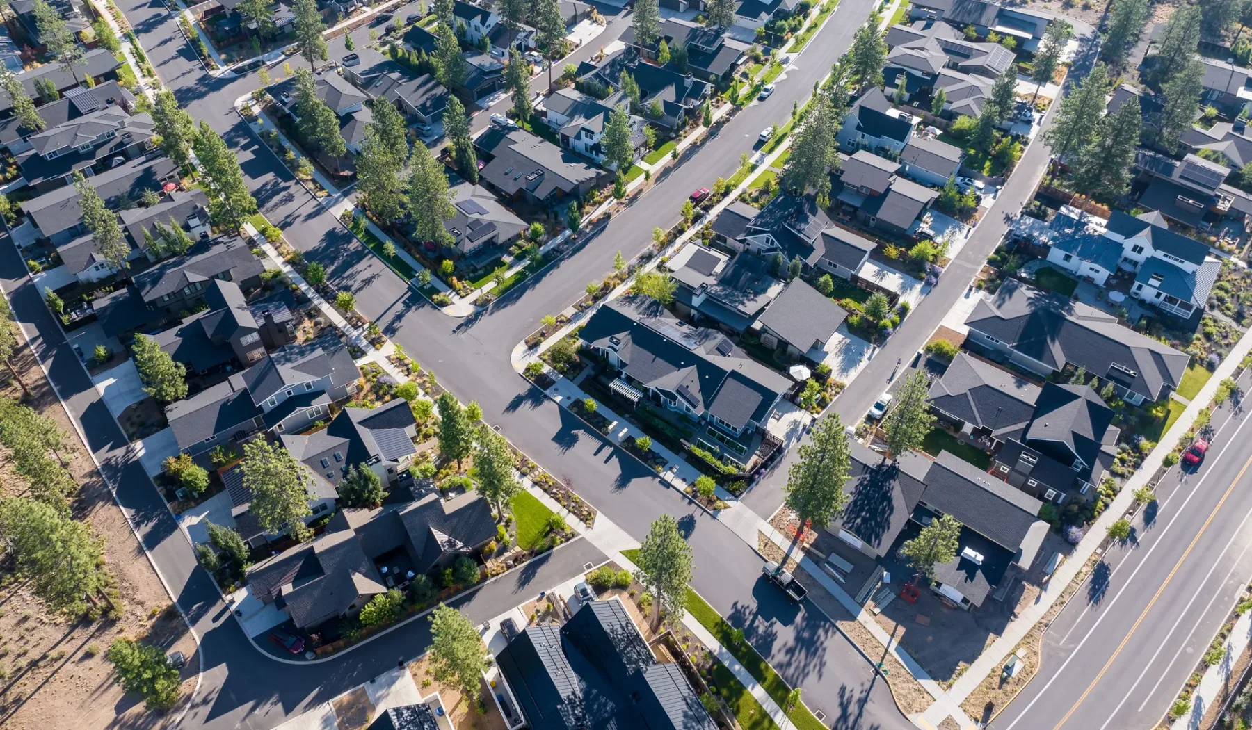 Aerial view of a residential neighborhood with homes along tree-lined streets.