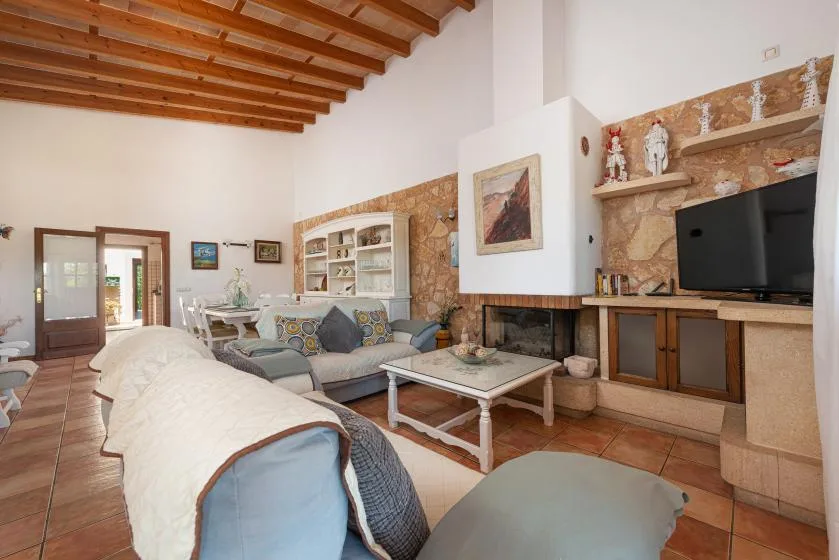 A living room with seating around a coffee table and a fireplace.