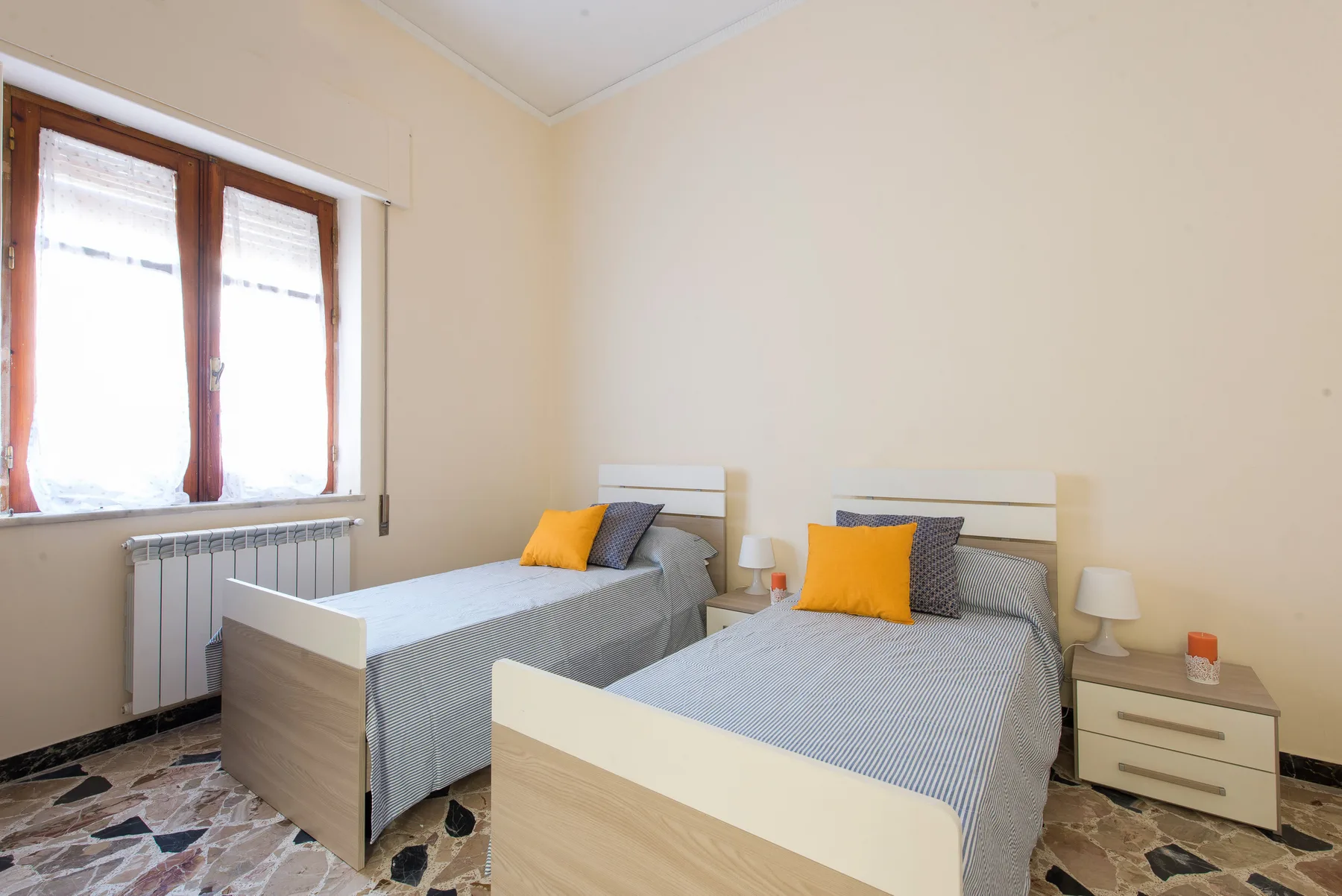 A bedroom with two single beds arranged side by side.