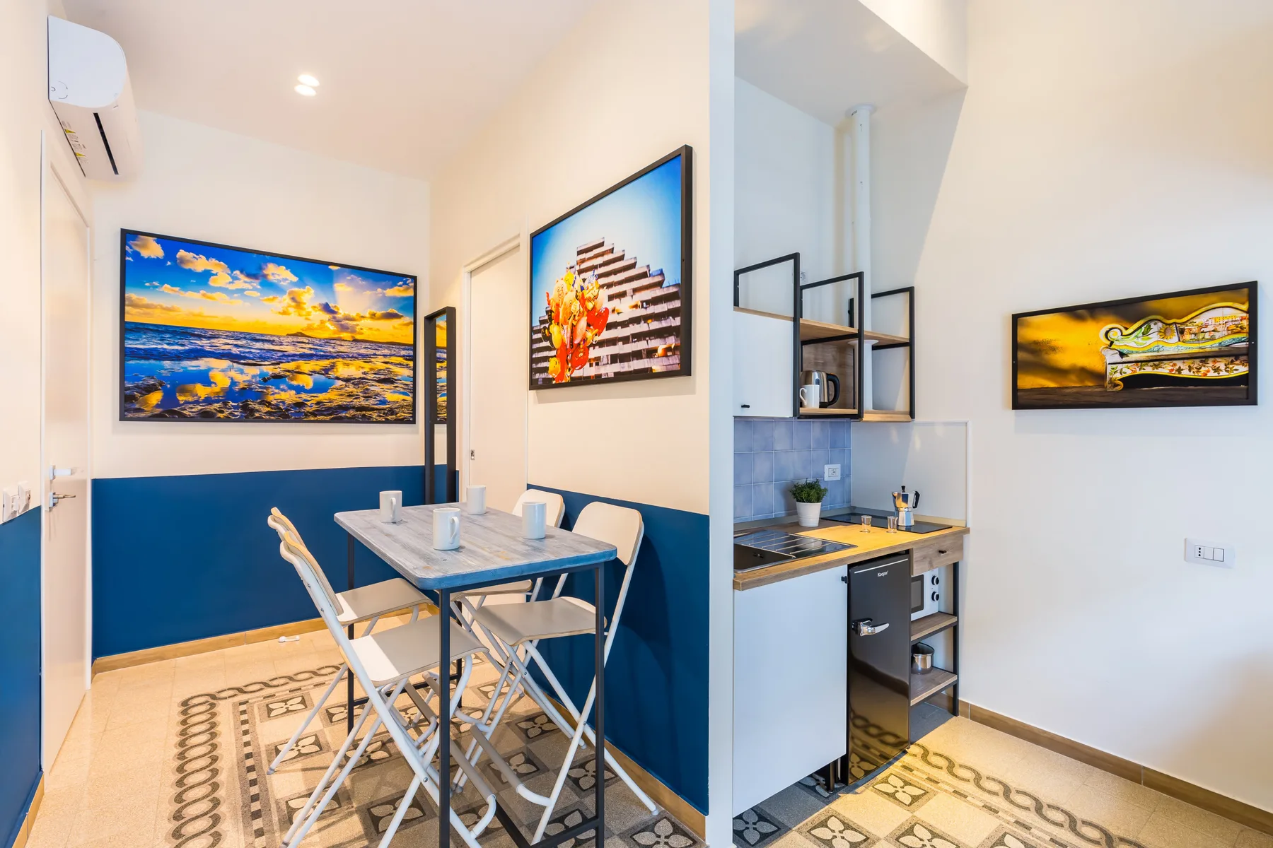 A compact dining area with a table and colorful wall art.