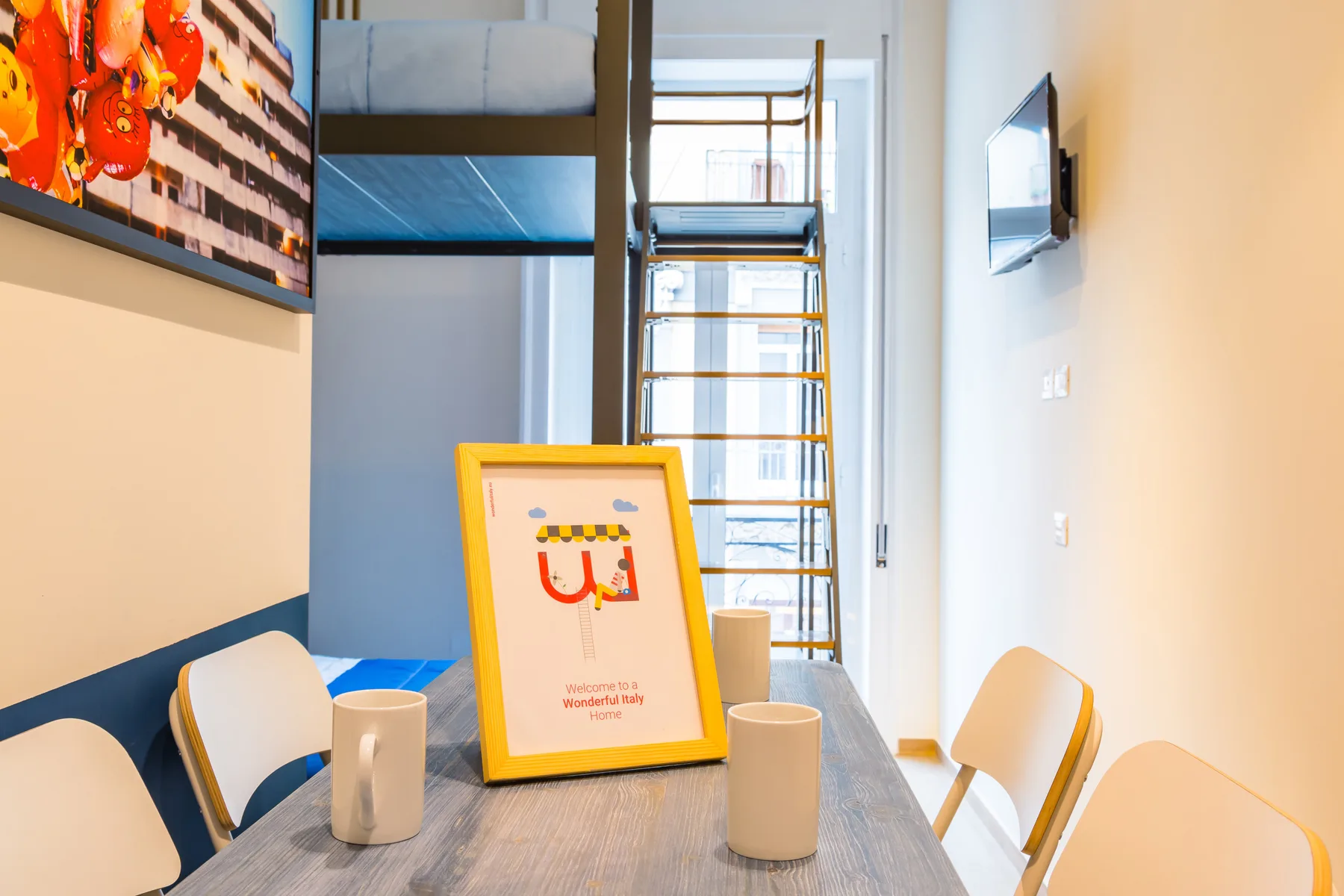 A dining table with seating sits in front of a bunk bed and ladder.