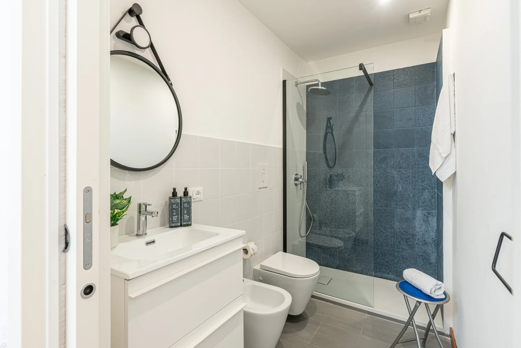 Un baño con lavabo, inodoro y ducha de vidrio.