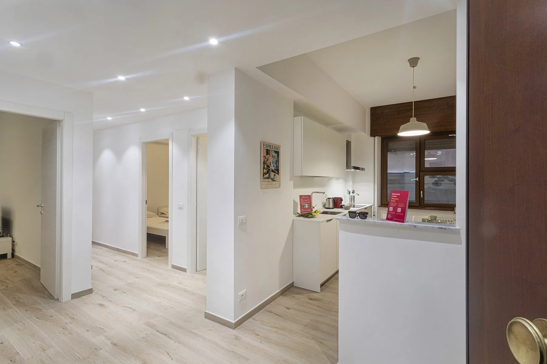 A bright open-plan kitchen and dining area with light wood flooring.