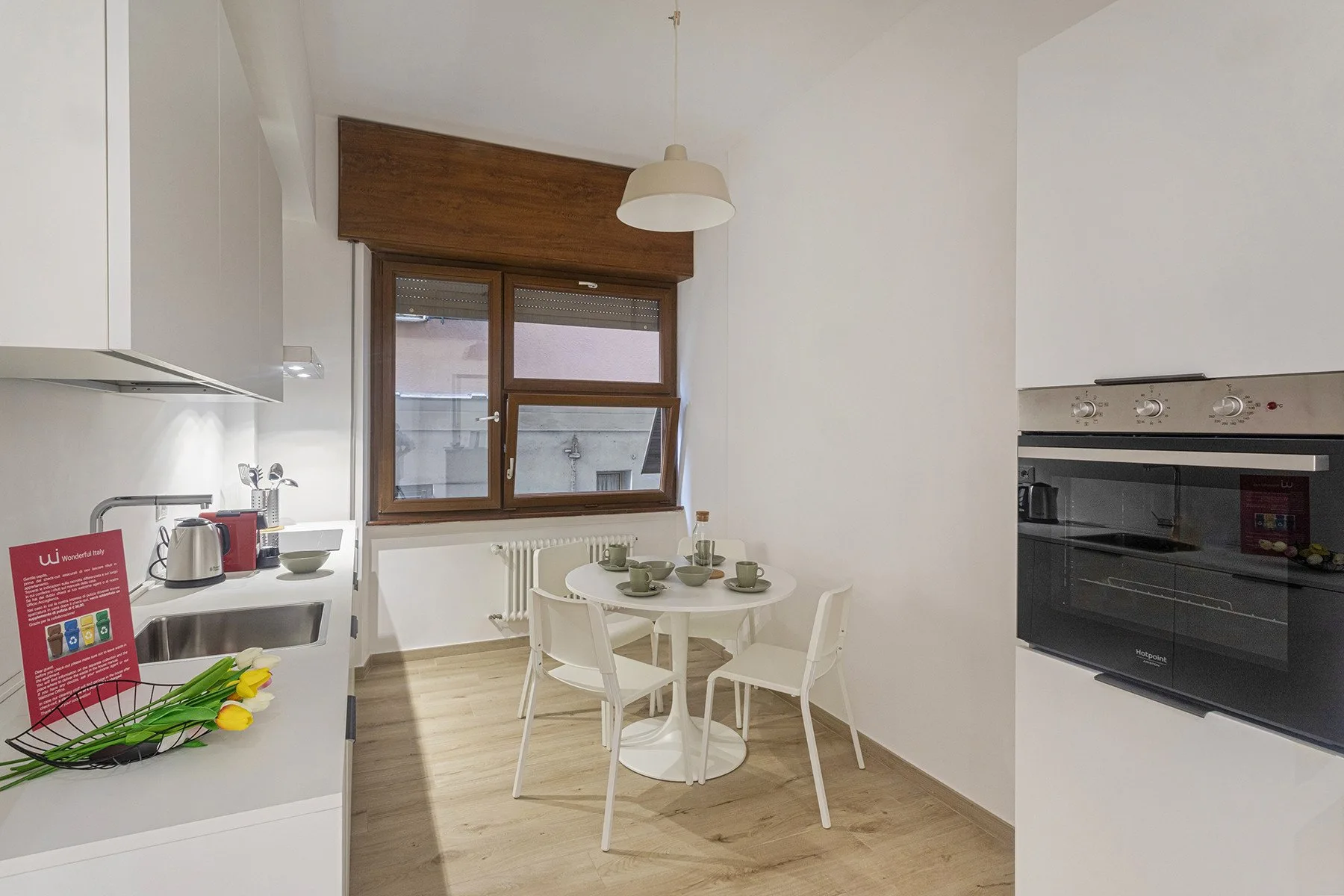 A bright kitchen with a dining table beside the window.