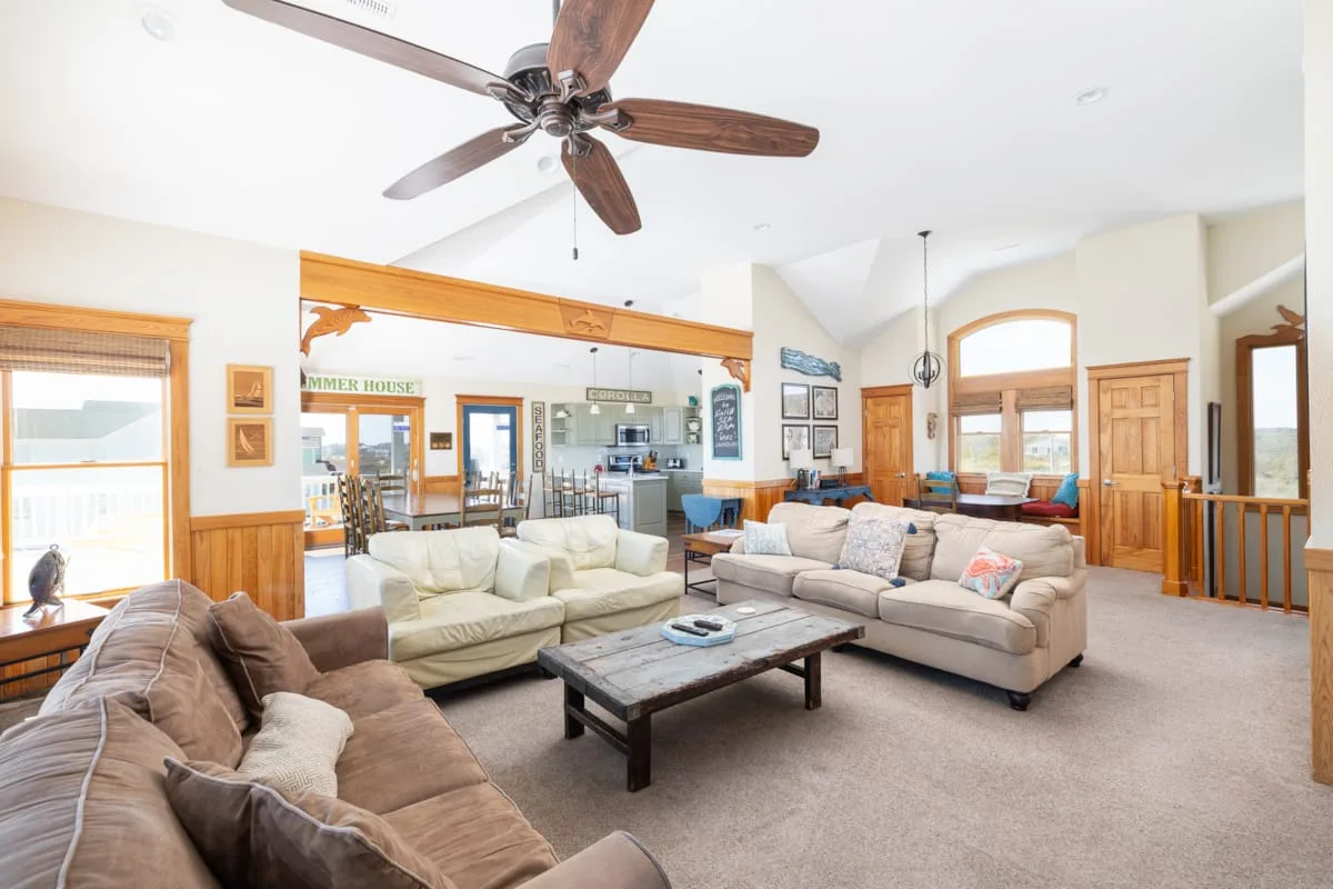 A bright living room with seating arranged around a coffee table.