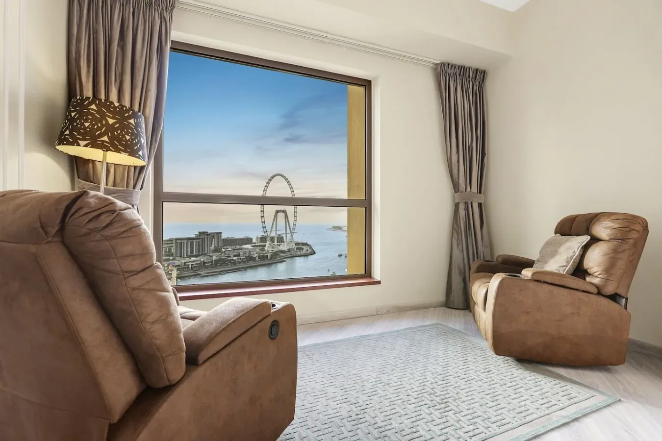 A sitting area with cushioned seating and a large window overlooking the waterfront.