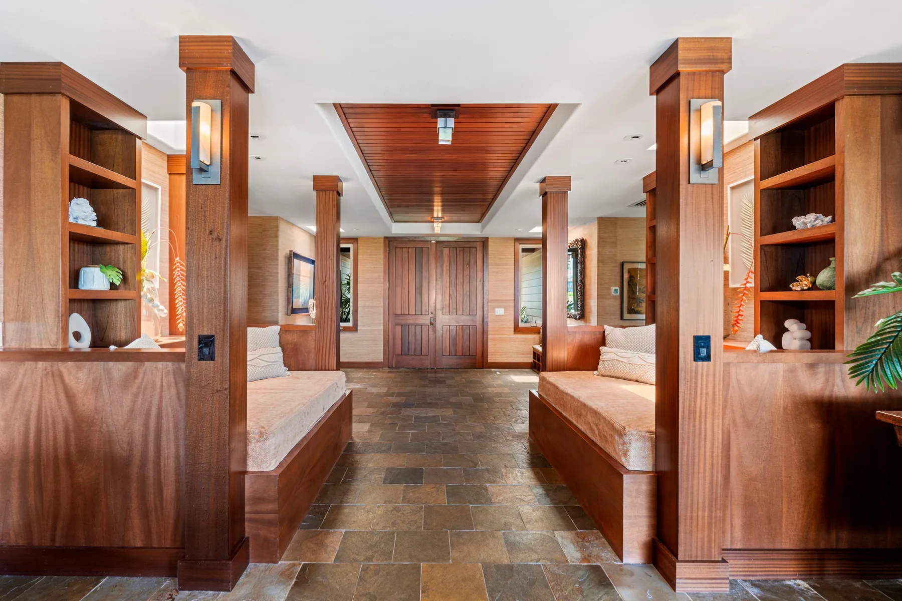A wood-paneled lounge with built-in seating and a central tiled walkway.