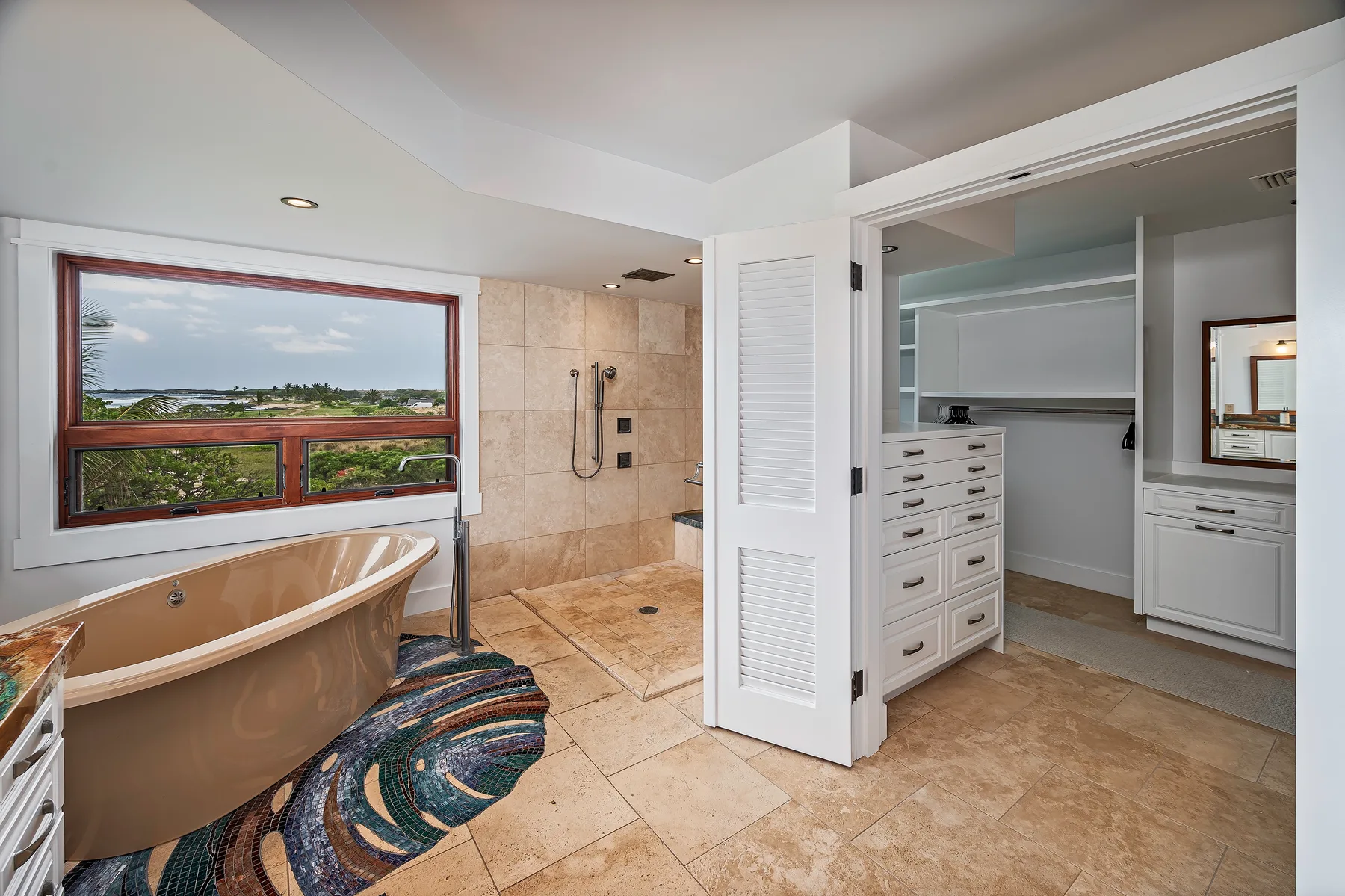 A spacious bathroom features a bathtub, walk-in shower, and open dressing area.