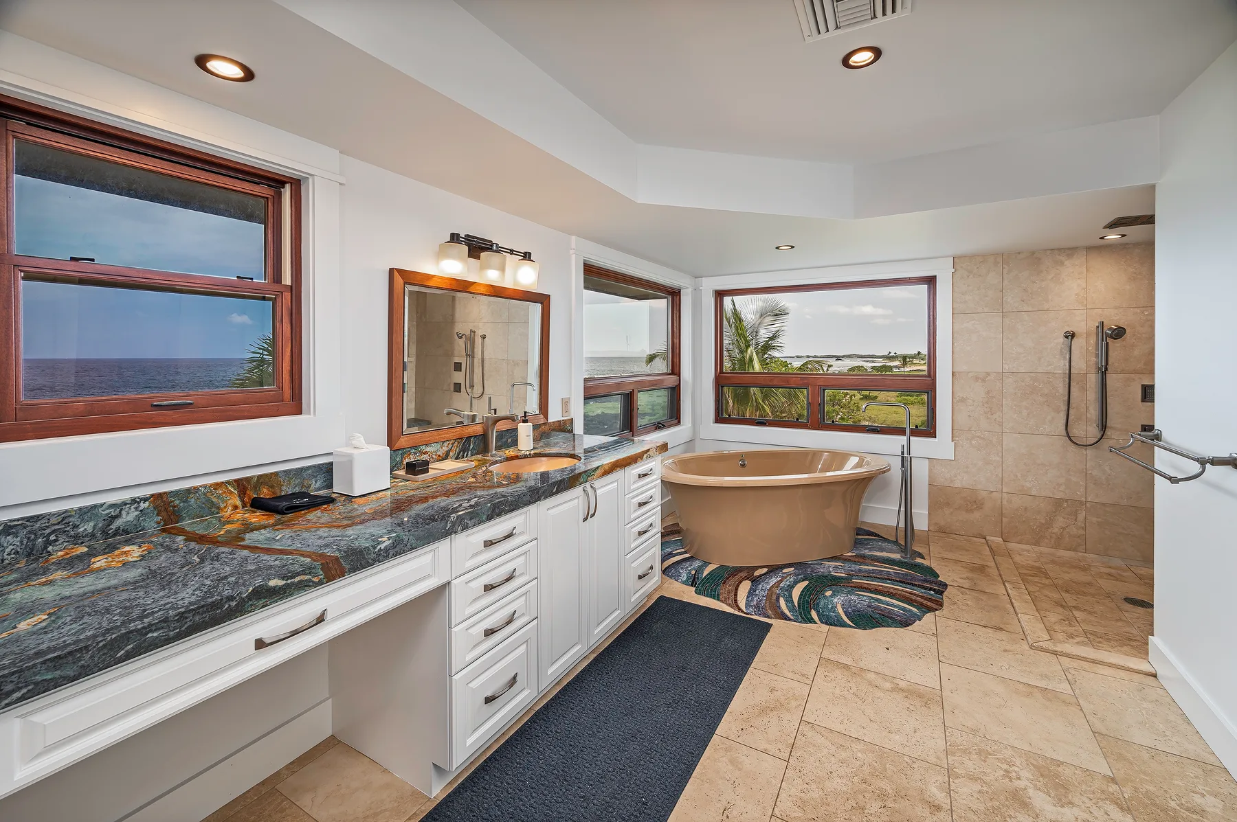 A bathroom with a long vanity, bathtub, and walk-in shower.