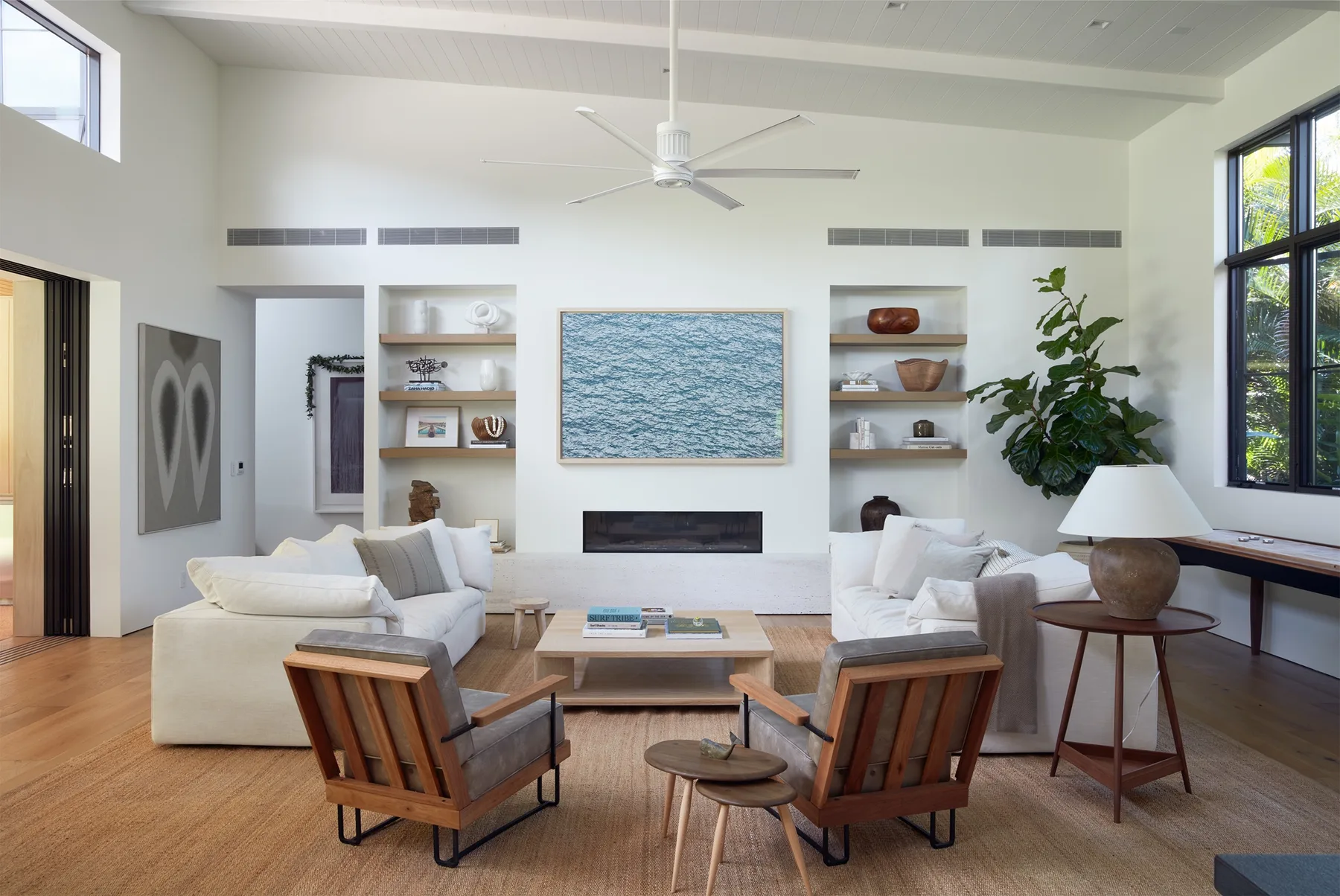 A bright living room with seating arranged around a low coffee table.