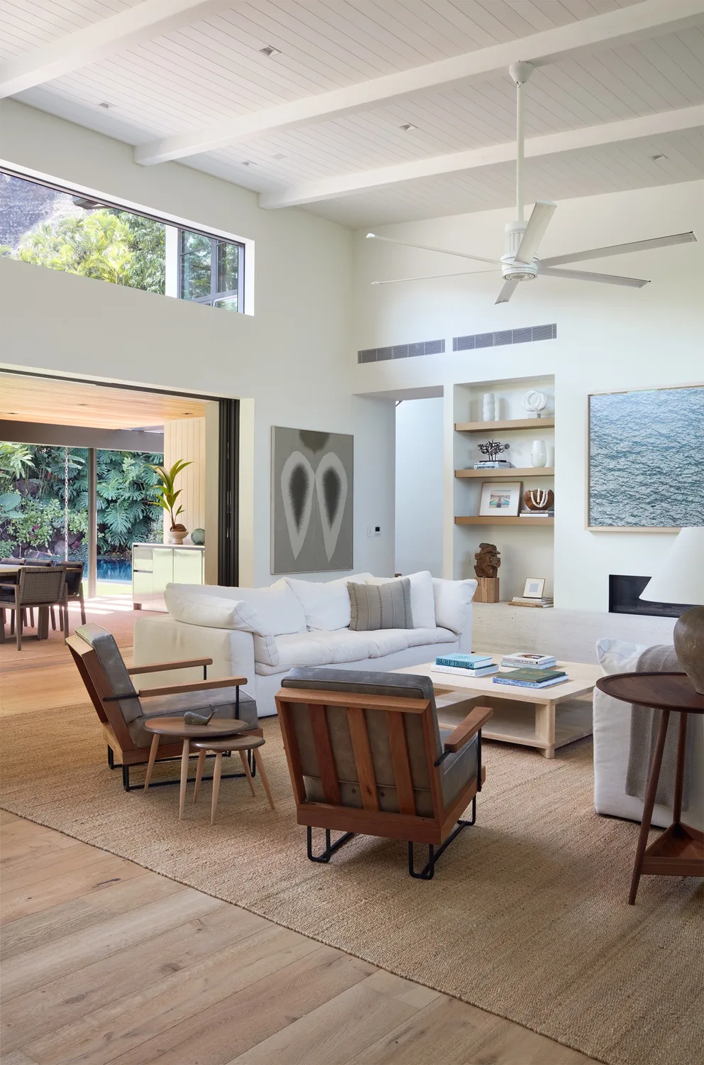 A bright living room with seating arranged around a coffee table.